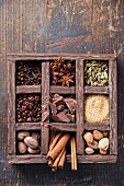 Assortment of spices and coffee beans in wooden box