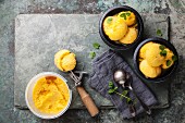 Mango ice cream sorbet with mint leaves in black bowls