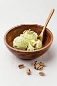 Pistachio ice cream in wooden bowl