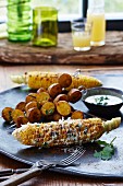 Barbeque potatoes and spicy corn cobs