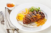 Fried duck breast with orange sauce