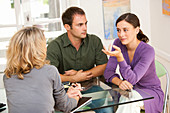 Couple talking to a woman