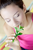 Woman smelling mint leaves