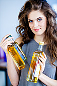 Woman holding oil bottles