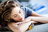 Woman resting on sofa