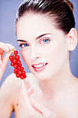 Woman eating red currants