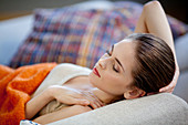 Woman relaxing on sofa