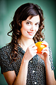 Woman peeling an orange