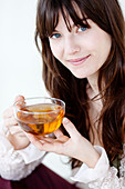 Woman drinking hot beverage