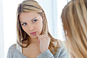 Young woman with finger on lips