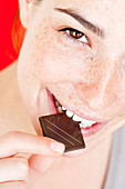 Woman eating chocolate