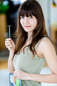 Woman holding IUD contraceptive