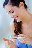 Woman softening her hands with oil
