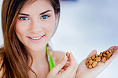 Woman eating almonds