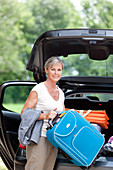 Woman holding some luggages