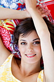 Smiling woman lying on sofa