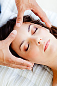 Woman receiving Reiki treatment