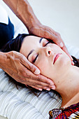 Woman receiving Reiki treatment