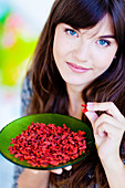 Woman eating goji berries