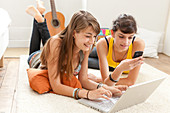 Teenage girls using a laptop