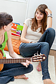 Teenage girl playing guitar