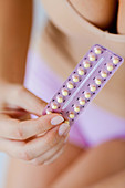 Woman with contraceptive pills