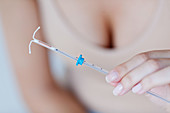 Woman holding IUD