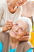 Woman helping elderly person