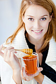 Woman eating honey