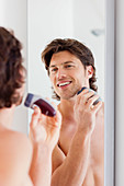 Man shaving with an electric shave