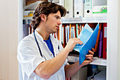 Doctor reading medical records