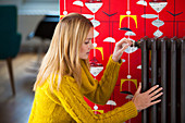 Woman adjusting a thermostatic valve