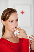 Woman using nasal spray