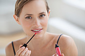 Woman applying gloss