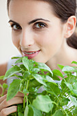 Woman smelling basil