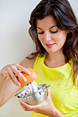 Woman squeezing grapefruit
