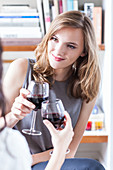 Women drinking red wine