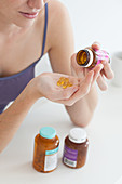 Woman taking food supplement