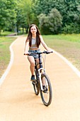 Girl riding bicycle on path