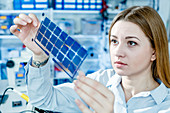 Girl holding film solar cells