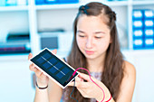 Girl working on solar cell in classroom