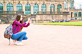 Young woman taking photo