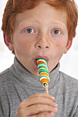Portrait of a boy sucking lollipop