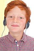 Boy wearing headphones smiling