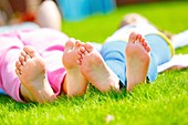 Children lying down on the grass