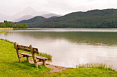 Empty bench by lake, Bavaria, Germany