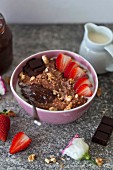Chocolate millet porridge with strawberries and dark chocolate