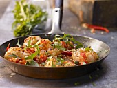 Mediterranean shrimp dish with chilli, tomatoes, capers and rocket