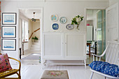 White cabinet between two doors in living room