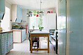 Pale blue cabinets and dining area in retro kitchen
